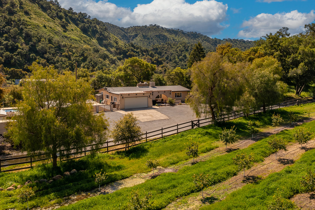 Aerial view of front of Ojai home with mountains in background