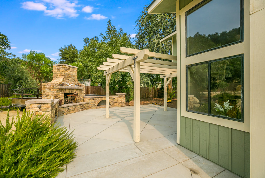 patio with pergola and stone fireplace