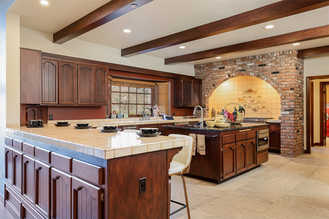 large kitchen with island and wolf range