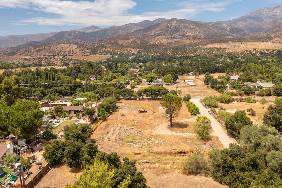 aerial view of upper ojai land with mountains in background