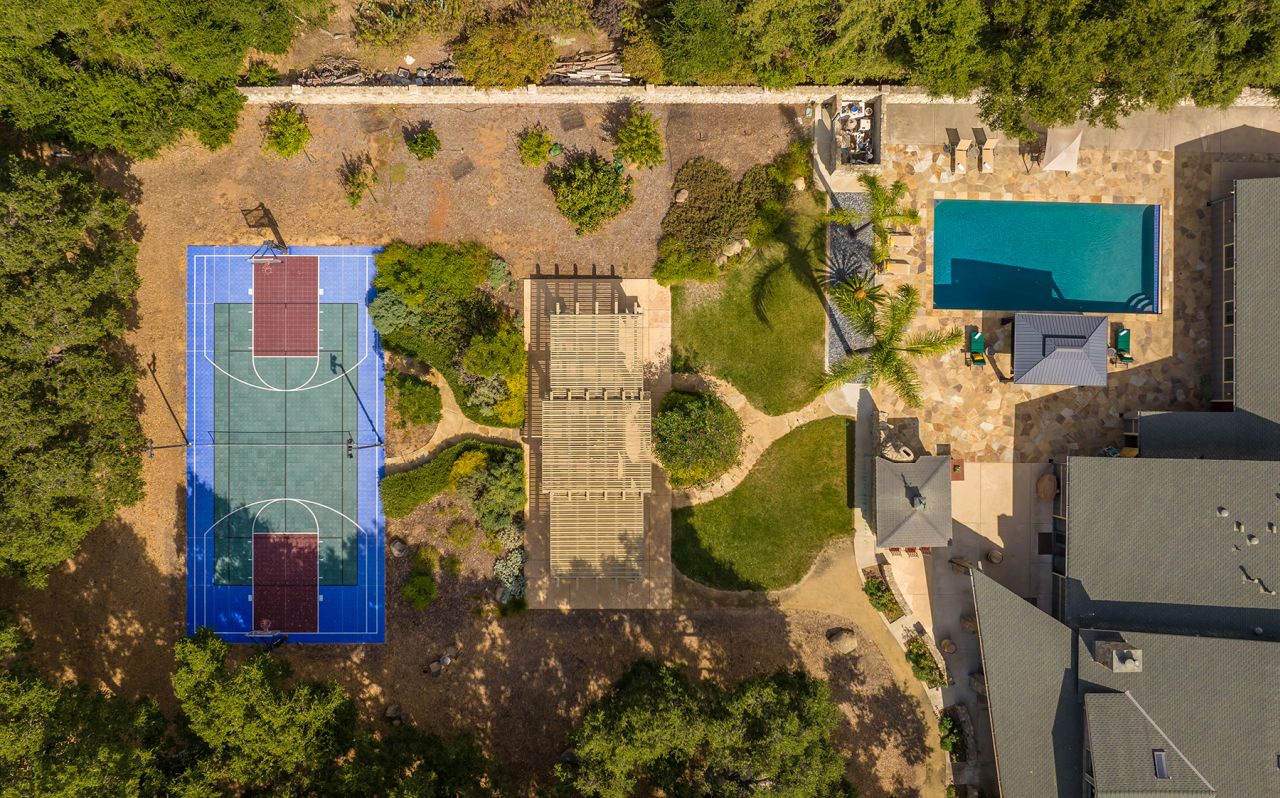 aerial view of outdoor living with pool and sports court
