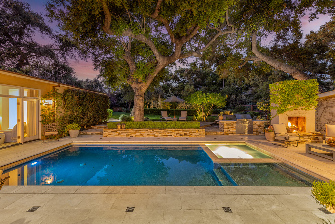 twilight image of pool and outdoor living area with oak trees in ojai